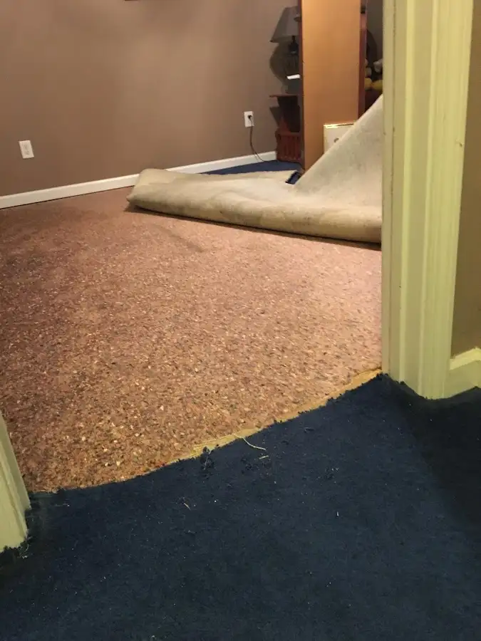 Carpet pad removal revealing water damage during Water Mitigation Services in Lake Havasu City
